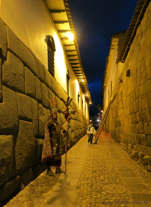 A man dressed up as an Inca king posing for photos in Cuzco.  